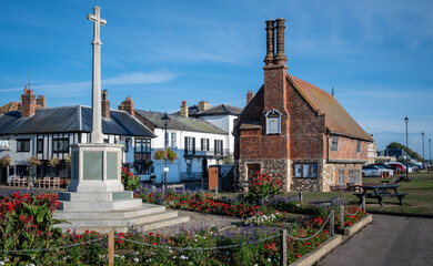 Tudor built Moot Hall on the seafront in Aldeburgh, on a summers day with the War Memorial surrounded by summer flowers