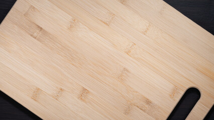 Empty wooden board on a black wood. Styled background for laying out objects