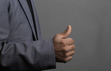 businessman giving thumbs up on black background with people stock photo