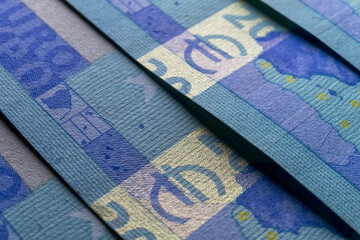 A macro image of the fluorescence ink and holographic features on a 20 Euro banknote, showcasing the security measures in place to prevent counterfeiting - 561240649