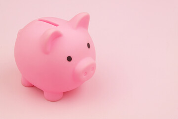 Piggy bank on pink background. Room for text.