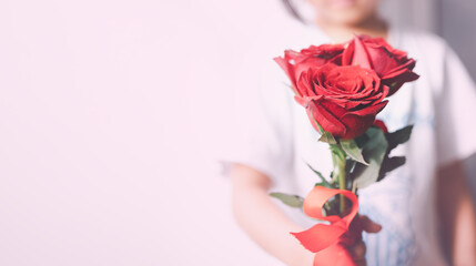 valentine's day concept of love, girl's hand holding roses and copy space background, encouragement 