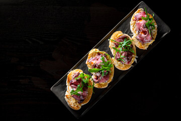 bruschetta with roast beef and cheese on plate