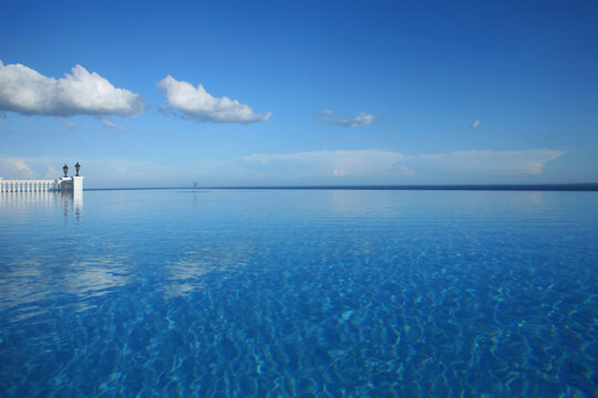 Enormous infinity pool beneath a blue sky at a hotel resort in the Philippines.
