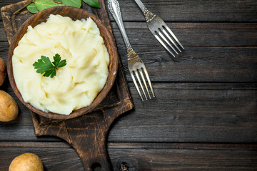 Mashed potatoes with a sprig of parsley .