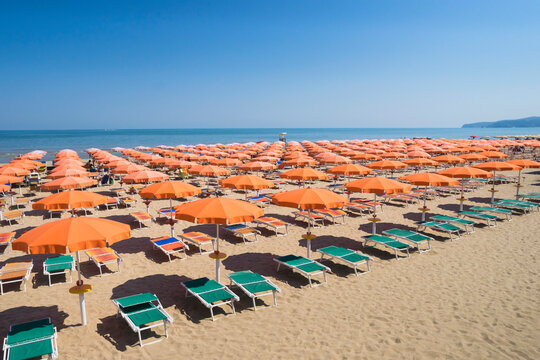 Umbrellas on sandy beach in Apulia, Italy