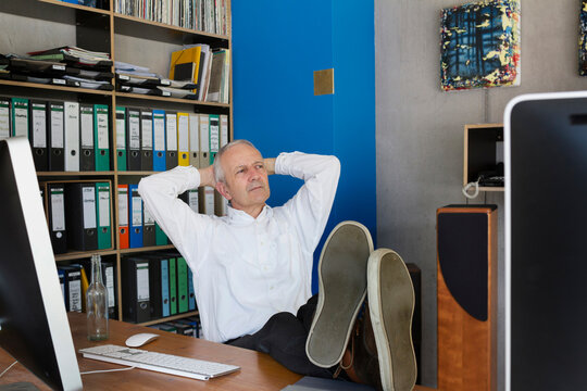 Senior businessman sitting in the office and thinking, Freiburg im Breisgau, Baden-W&uuml;rttemberg, Germany