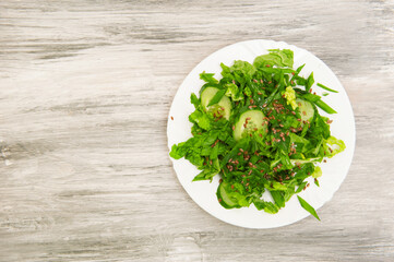 Fresh green salad on plate top view