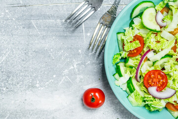 Vegetable salad. Salad of cucumbers, tomatoes and red onions with spices and olive oil.