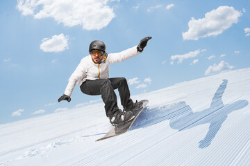 Man gliding downhill with a snowboard