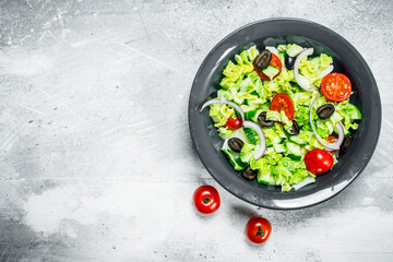 Vegetable salad. Salad of cucumbers, tomatoes and red onions with spices and olive oil.