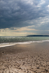 Looking towards the headland at Fairlight Cove, from Camber Sands in Sussex