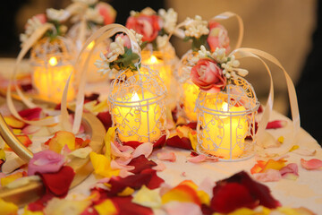 Beautiful composition with burning candles and flowers on table