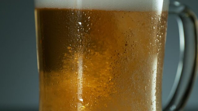 Super slow motion of pouring beer into pint in motion. Filmed on high speed cinema camera, 1000 fps. Camera placed on high speed cine bot. Speed ramp effect.