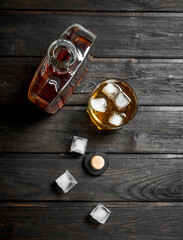 Whiskey in a bottle with ice cubes.