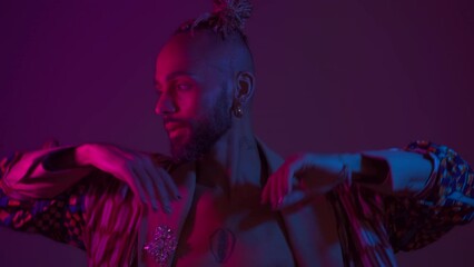 Neon light studio close-up portrait handsome black gay man looking camera. Seductive sexy man wear make up, transgender person dance in ultraviolet light. LGBT nightclub dancer nightlife concept  - Powered by Adobe