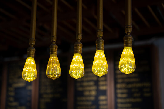 Glowing vintage light bulbs in coffee shop
