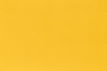 pattern of bright yellow painted old plaster wall