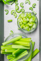 Pieces of celery in a bowl on a tray.