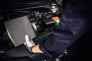 Car air conditioner system maintenance, Hand mechanic holding car air filter to check for clean...