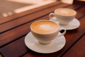 Two cups of cappuccino with latte art