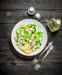 Healthy salad. Salad with cucumbers, chicken and Chinese cabbage poured lemon juice .