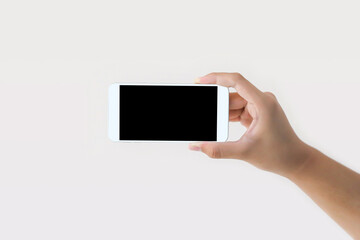 Hand holding blank screen phone or smartphone or tablet for template