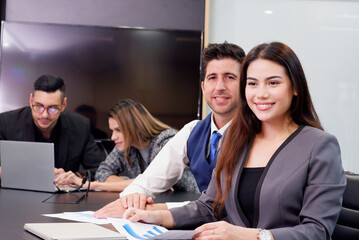 Businessmen and employees meeting using laptops in the conference room.