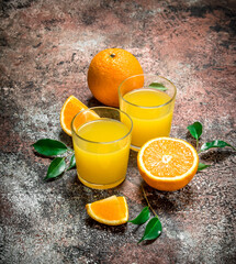 Orange juice in a glass of fresh oranges.