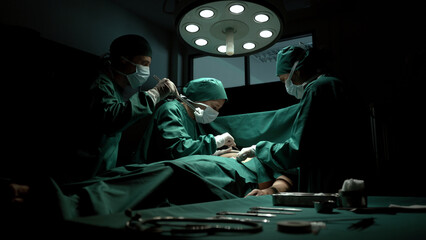 Medical team performing surgery in operation room.