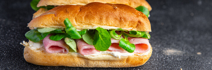 sandwich ham french milk bun, cheese, lettuce green leaves bio product fresh healthy meal food snack on the table copy space food background rustic top view