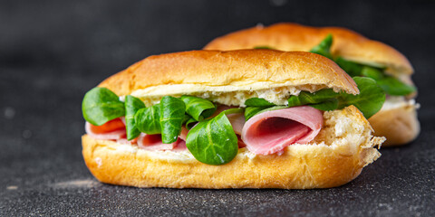 sandwich ham french milk bun, cheese, lettuce green leaves bio product fresh healthy meal food snack on the table copy space food background rustic top view