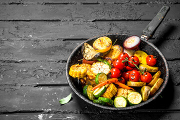 Grilled vegetables in a pan with herbs and spices.