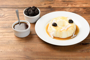  coconut blancmange with prune syrup on a white plate
