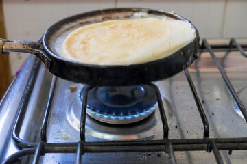 woman preparing the mixture of flour and water to make pancakes