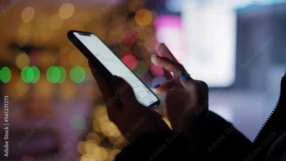 Aufkleber cropped view, female hands holding in darkness smartphone with illuminated screen. typing text messa