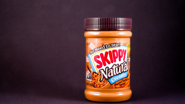 NORWALK, CT, USA, - JANUARY 13, 2023: Skippy peanut butter spread package isolated on dark background