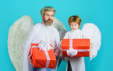 Valentine day celebration. Valentines Angels father and son with present gift box.