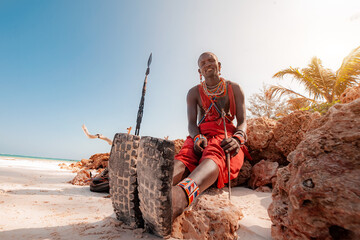 Maasai warrior on the beach Diani Beach, Kenya Mombasa January 26 2012 - obrazy, fototapety, plakaty
