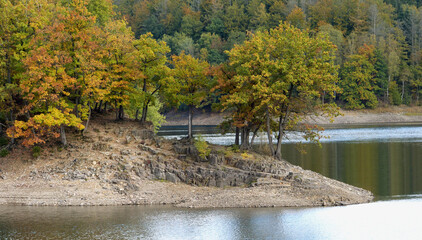 Beautiful scenery of colorful trees on a late summer day at a lake.