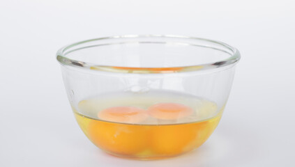 Raw eggs in a glass cup