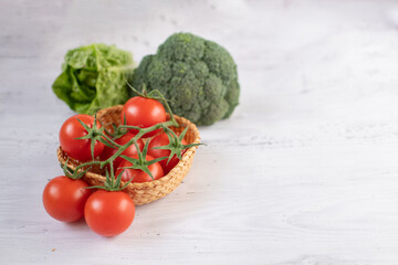 fresh vegetables on a table. cherry tomatoes, broccoli, cabbage, healthy eating