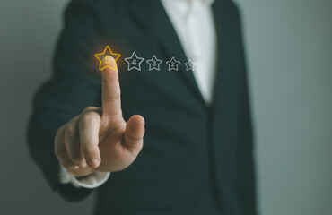 Businessman pointing five star symbol to increase rating of company