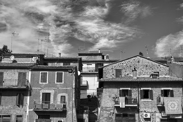 Roofs with antennas and walls with windows and balconies in a small town in Tuscany