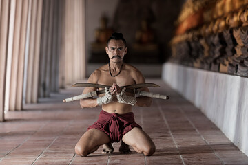 A man model in Tradition Thai old style dress and preparing to show Thai Boxing, Muay Thai Sword...