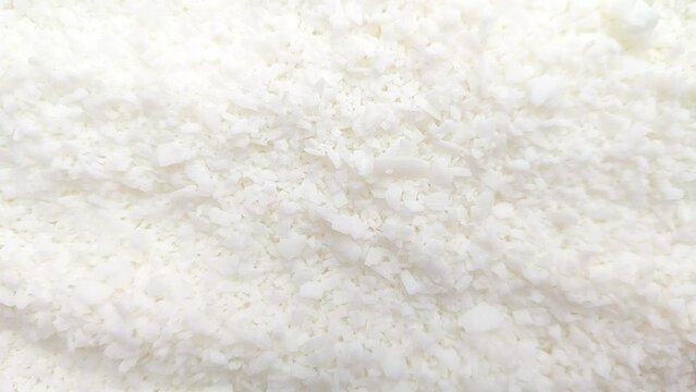 macro shot of soy wax flakes for candle making. Soy wax flakes falling