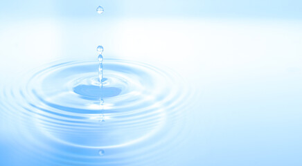 Waves of water are caused by falling droplets. close-up view.