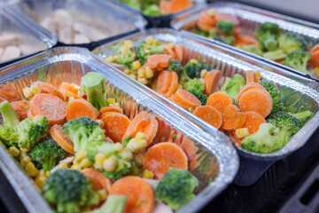Raw chicken breast with vegetables in baking tray ready for oven