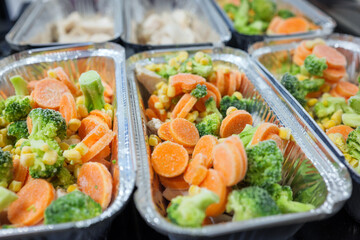 Raw chicken breast with vegetables in baking tray ready for oven