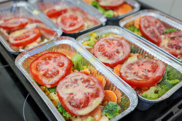 Raw chicken breast with vegetables in baking tray ready for oven